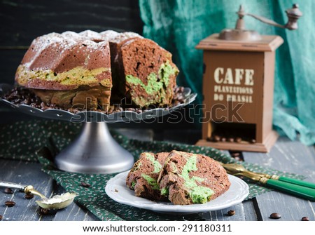 Chocolate cake with tea match on wooden background