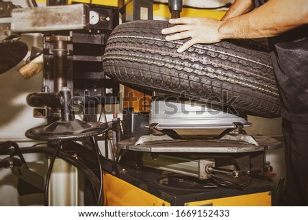Concept of changing tires for safer driving : Professional technicians put new tires on pickup trucks using modern and safe tools, saving time in service stations.
 Stock fotó © 