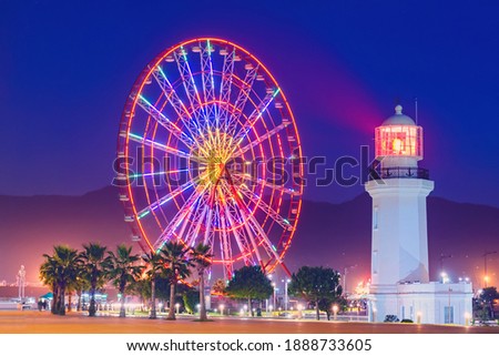 Ferris wheel at amusement theme park in the evening time. Batumi Boulevard. Photo is taken with a long exposure and has motion blur.  Сток-фото © 