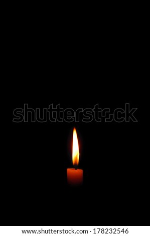 Candle burning in the dark