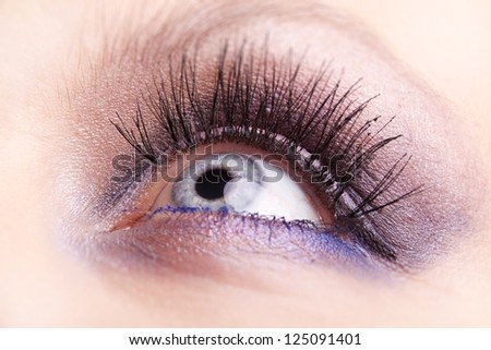 Women eye, close-up, painted blue