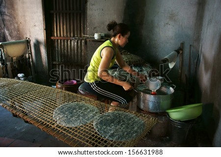 BA RIA, VIET NAM- FEBRUARY 2 .Woman make girdle cake (banh trang) - is the usual rice flour\'s cake of Viet Nam- at trational trade village, Ba Ria, February 2, 2013
