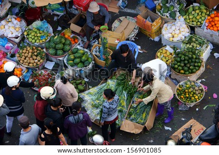 DA LAT, VIET NAM- FEBRUARY 8.People sell and buy fruit at open air   market, many kind of fruit as: pineapple, apple, waterlemon,blue dragon, rambutan, citrus..  Dalat, Viet Nam- February 8, 2013