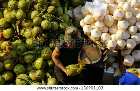 DA LAT, VIET NAM- FEBRUARY 8: People sell and buy coconut at farmers market in  Dalat, Viet Nam- February 8, 2013