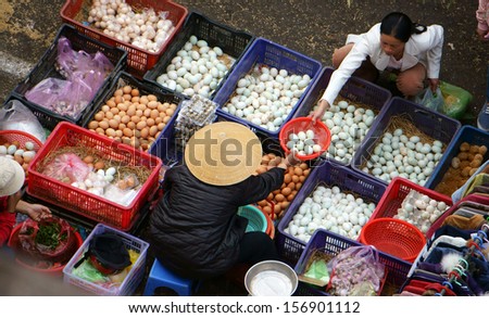 DA LAT, VIET NAM- FEBRUARY 8.People sell and buy hen eggs, duck eggs at farmers market in  Dalat, Viet Nam- February 8, 2013
