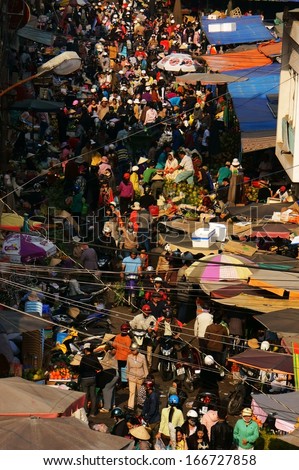 DA LAT, VIET NAM- FEB 8: Crowded, busy scene \'s market with crowd of people go to markets to buy goods repair for Tet (Lunar New Year) in Da Lat, Viet Nam on February 8, 2013