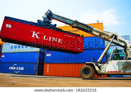 HO CHI MINH CITY, VIET NAM- MAR 19 :  Forklift truck crane container at  freight depot, cargo box in stack, this industrial port is logistic service of import, export  goods ,Vietnam, Mar 19, 2014