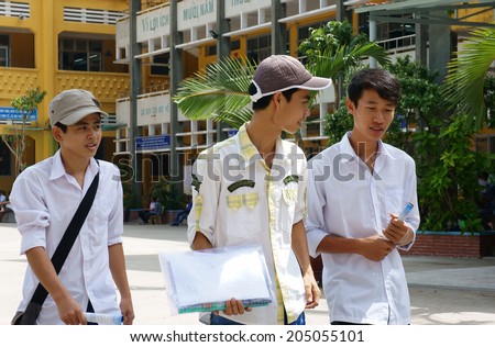 HO CHI MINH CITY, VIETNAM- JULY 15: Group of Asian high school student finish university entrance exam, schoolboy walking in happy, this time is examination season in Viet Nam, July 15, 2014