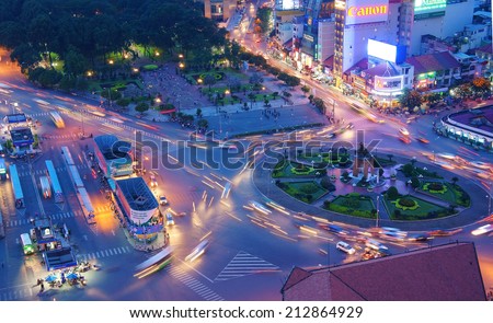 HO CHI MINH, VIETNAM- AUG 21: Impression, colorful, vibrant scene of Asia traffic, dynamic, crowded city with trail on street, Quach Thi Trang roundabout at Ben Thanh bus stop, Vietnam, Aug 21,2014