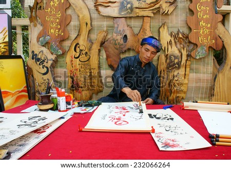 HO CHI MINH CITY, VIET NAM- JAN 19: Vietnamese calligrapher writing calligraphy letter at fair, a traditional ceremony, man in tradition dress, Vietnam, Jan 19, 2014
