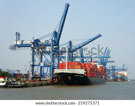HO CHI MINH CITY, VIET NAM- FEB11: Transportation for export, import at Cat Lai port on Sai Gon river, crane load container to boat, this harbor is big industry service for trade, Vietnam, Feb 11,2015