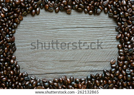 Coffee bean background on wooden texture, brown cafe beans and grey color can make amazing, simple frame