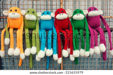 Amazing handmade product, group of colorful homemade monkey with funny humorous , knitted monkeys, knit from wool, woolen toy to happy new year, fun animal