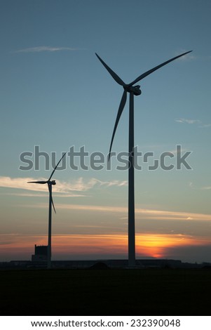 Two windmill silhouettes at sunset
