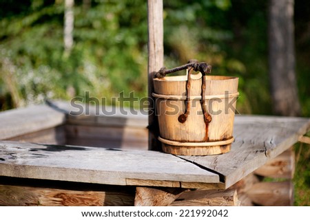 Old wooden bucket on the well