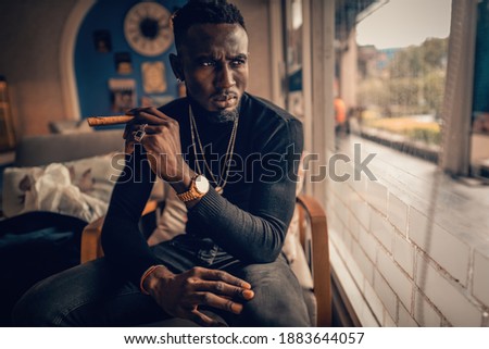 Similar – Image, Stock Photo Black man smoking in studio with neon illumination