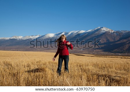 beauty woman goes on yellow field