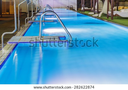 Hotel swimming pool with night lighting fittings under water .