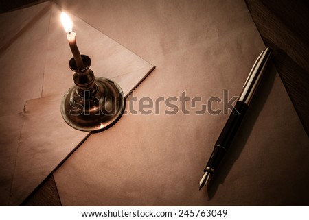 Letter, pen and candle. vintage style. red toning.