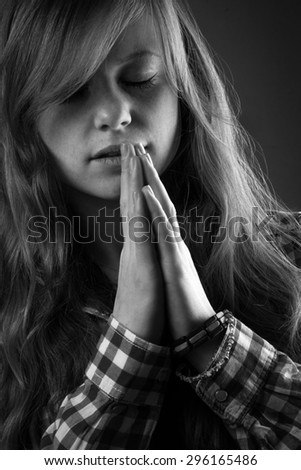 Prayer. Black and white portrait of young woman