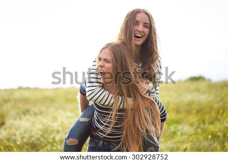 Two girls making fun outdoors