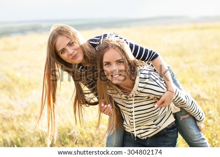Two girls making fun on the field