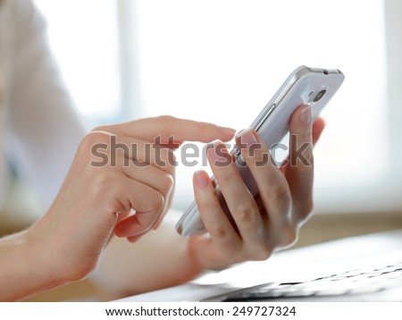 Woman Using Her Mobile Smart Phone at Home. Close-up of Mobile Phone