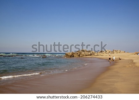 DURBAN, SOUTH AFRICA - JULY 11, 2014: Many unknown people enjoy low tide at Umdloti beach in Durban, South Africa