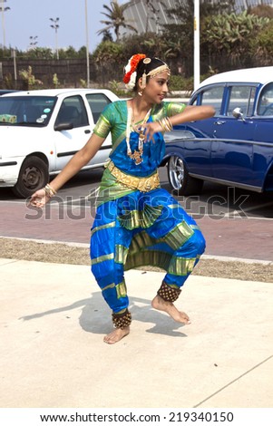 DURBAN, SOUTH AFRICA - SEPTEMBER 24, 2014: Unknown young woman  doing traditional Indian dance on promenade at the Heritage Day Walk along beachfront in Durban, South Africa.