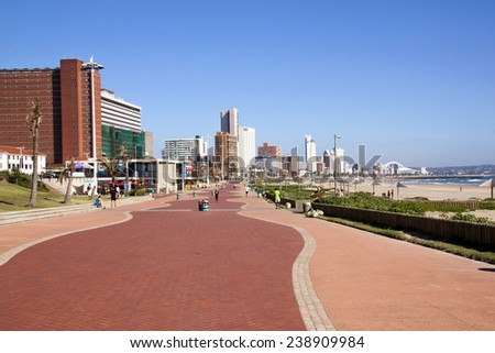 DURBAN, SOUTH AFRICA - DECEMBER 18, 2014: Many unknown people walk on promenade along Addington Beach against \