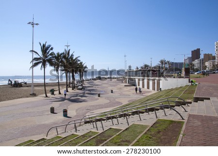 DURBAN, SOUTH AFRICA - DECEMBER 4, 2014: Many unknown people on early morning beach front promenade in Durban South Africa