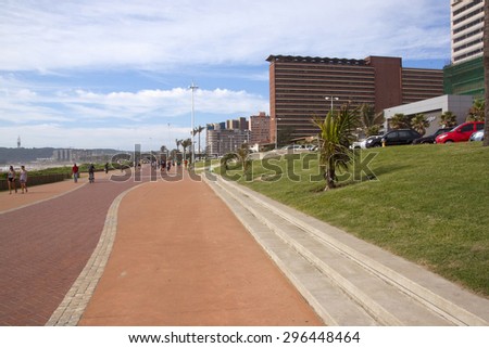 DURBAN; SOUTH AFRICA - MARCH 15; 2015: Many unknown people walk along promenade on Durban\'s Golden Mile beachfront