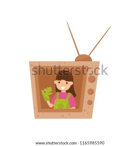 Adorable smiling girl sitting in TV made of cardboard box and playing with toy dragon on hand. Flat vector design