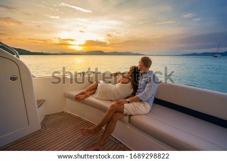 Similar – Image, Stock Photo Loving couple in boat. Top view of beautiful young couple embracing and smiling while lying in the boat.