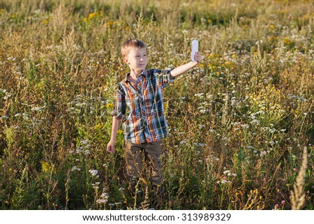 boy make selfie on nature