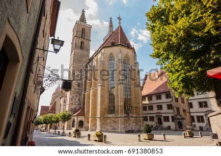 Beautiful postcard day view of St. Jakob or St. James Church or St. Jakob Kirche, Rothenburg ob der Tauber, Germany. one of the favorite's attraction of Germany's Romantic Road driving destination. Stock fotó © 