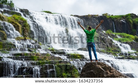 Image, Stock Photo Traveling man near waterfall in mountains