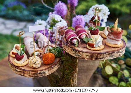 Different canapes with smoked salmon, cucumber, tomatoes, cheese, meat. Breakfast buffet table with a variety of snacks. Buffet served table with snacks,fruits,canape,sweets and appetizers. Photo stock © 