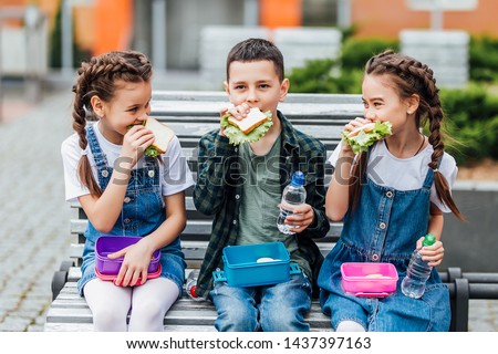 Similar – Image, Stock Photo Child eats sandwich outdoor