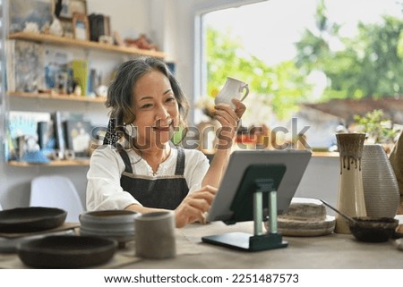 Similar – Image, Stock Photo Senior craftswoman with tablet computer in art studio