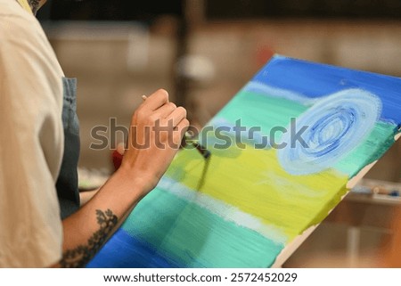 Similar – Image, Stock Photo Focused artist blending paints in palette