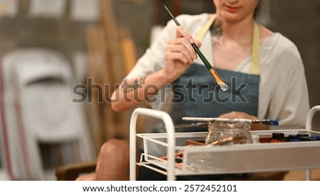 Similar – Image, Stock Photo Focused artist blending paints in palette
