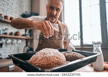 Similar – Foto Bild Männlicher Bäcker schiebt Kuchen in den Ofen