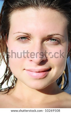 Young woman lets the sun shine on her face