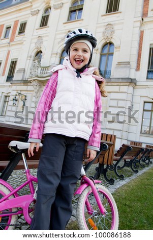 Cycling - portrait of lovely girl with bike in  the park