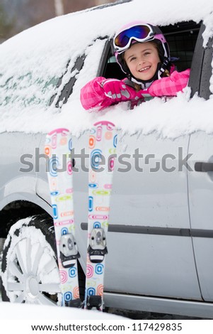 Winter holiday, ski - happy child on the road for ski holidays