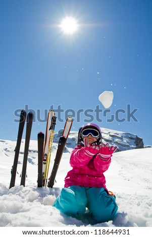 Winter fun, ski, snow and sun - lovely skier girl enjoying the snow