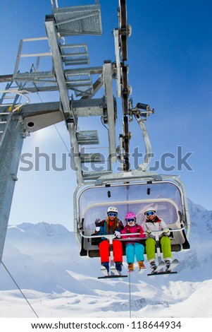 Ski lift, skiing, ski resort  - happy skiers on ski lift