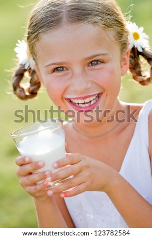 Healthy kid, milk - Portrait of lovely girl drinking fresh milk outdoors