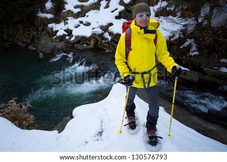 Hiking, hiker in spring mountains, snowshoeing - woman on hike